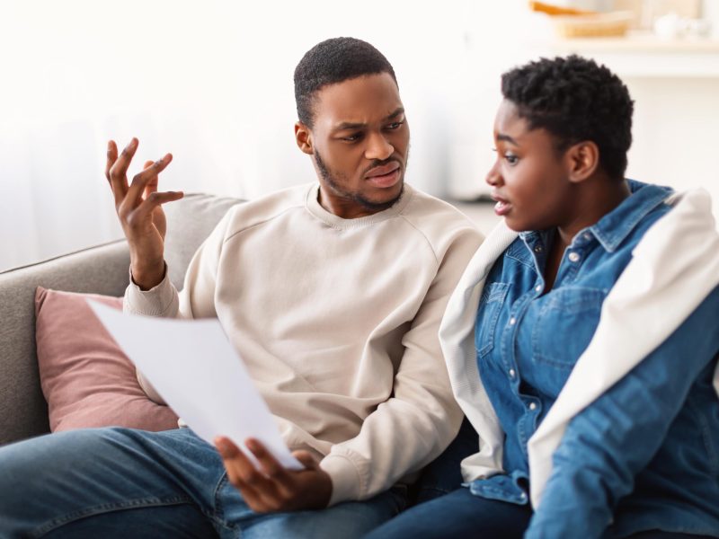 confused_afro_couple_reading_documentation_at_home_2023_11_27_05-min