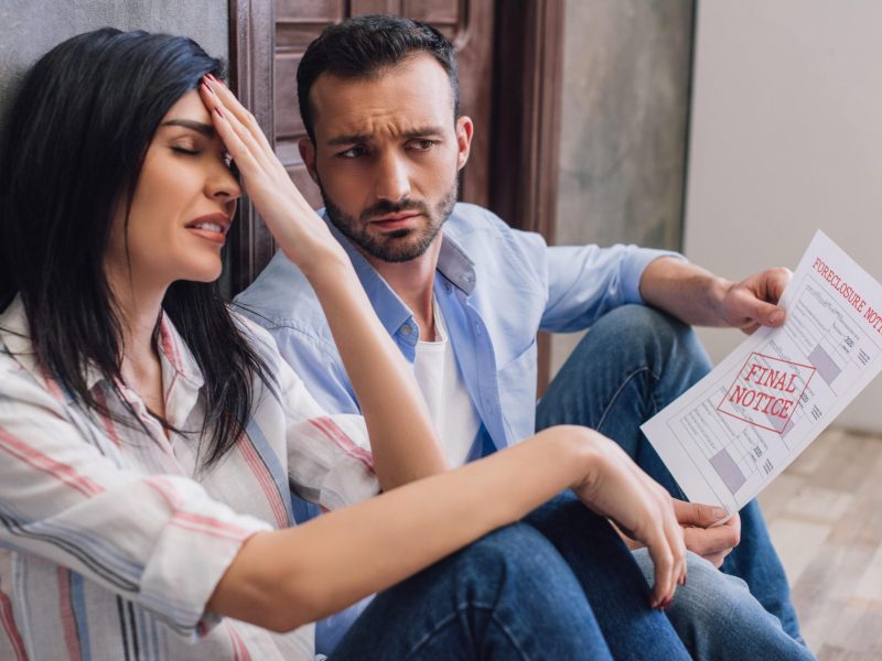 stressed_woman_with_husband_holding_document_with_2023_11_27_05-min